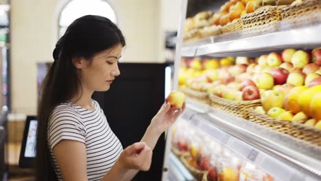 and-Asian-shot-visitor-chooses-fruits.-Hold-a-basket-in-your-hands.-Choice-of-products-in-the-store