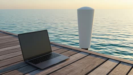 a serene view of a laptop positioned on a wooden dock overlooking a tranquil body of water during sunset
