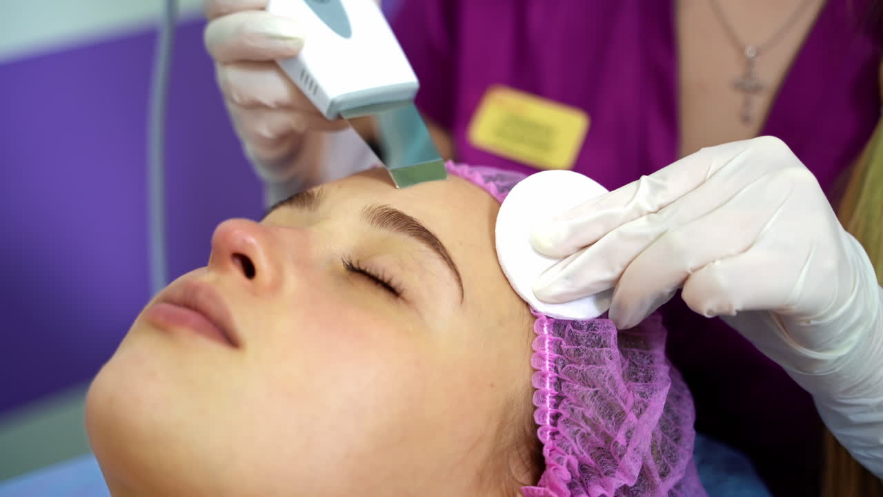 Ultrasonic scraber. Procedure of ultrasonic cleaning of face. Cosmetological clinic. Healthcare, clinic, cosmetology. Video from the top.