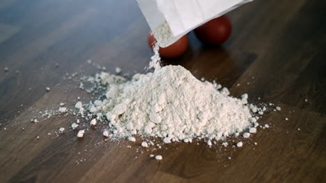 pouring flour on wooden table for baking preparation