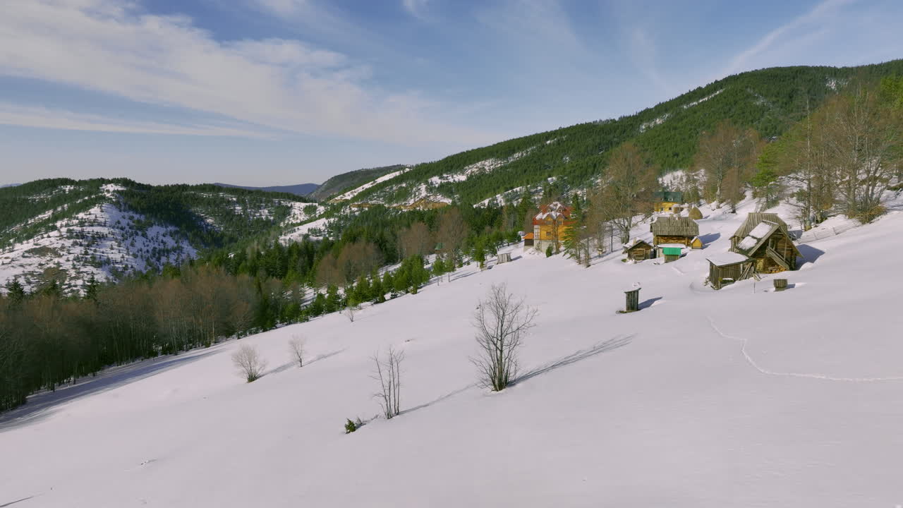 Winter Mountain Village with Traditional Wooden Cabins
