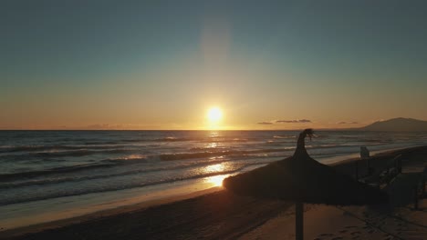 aerial view of sunset at the beach moving upwards