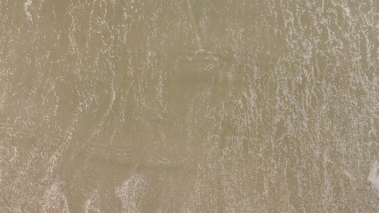 Foamy Ocean Waves Washing Sand Of Tropical Beach - Top Down View