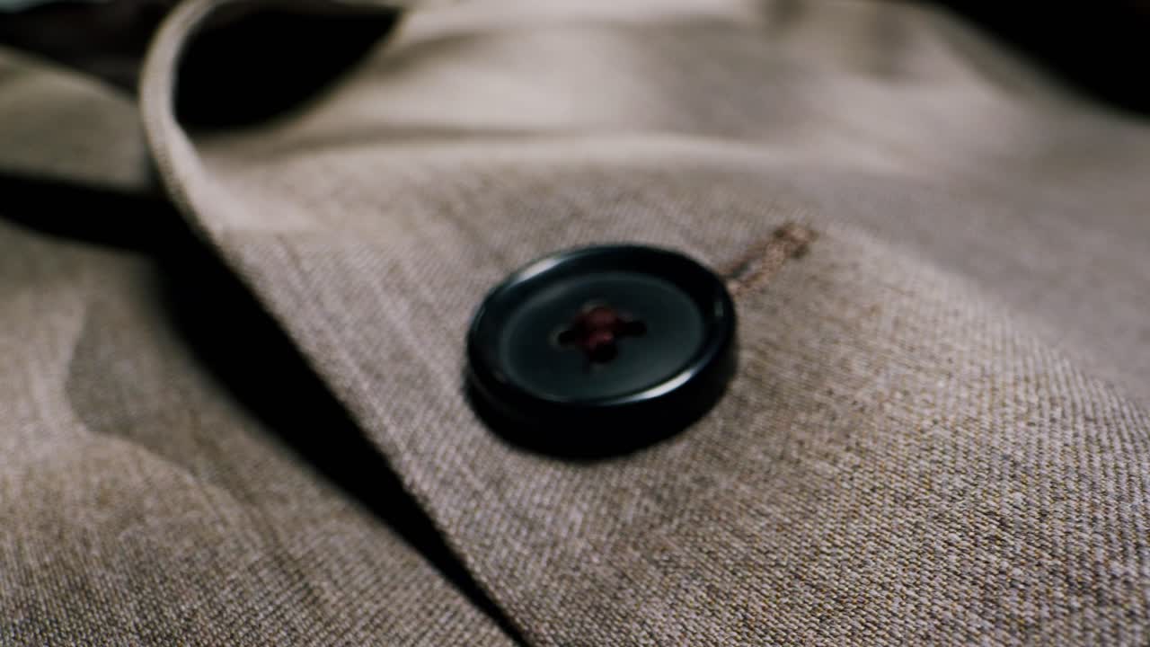 Closeup of an expertly tailored suit that beautifully showcases its sophisticated buttons and fine fabric texture