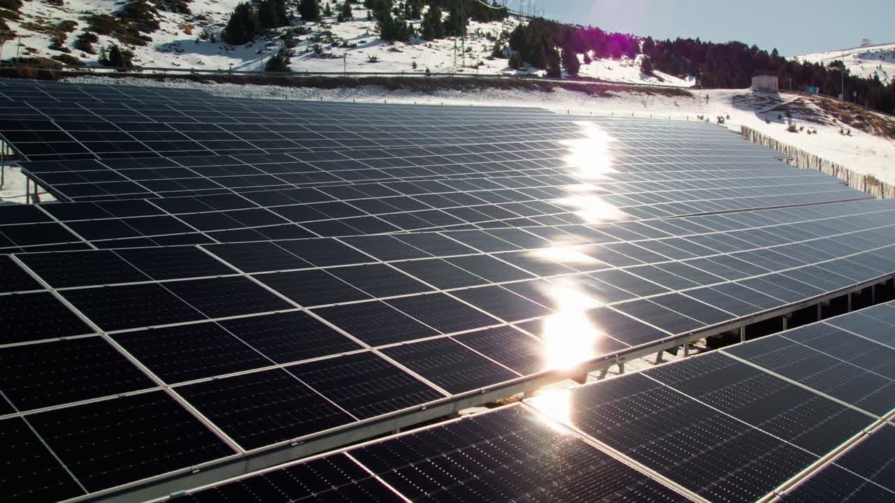 Flying over solar panels in the winter, close up aerial