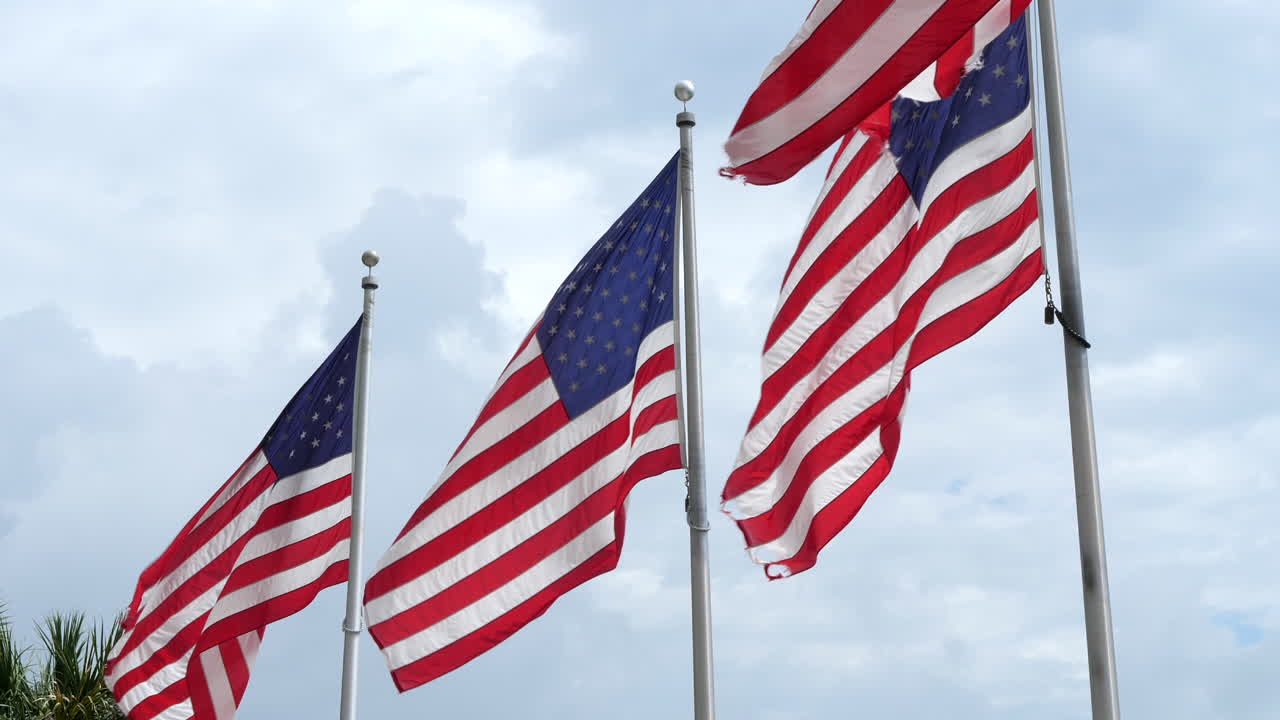 American flags fluttering against cloudy sky