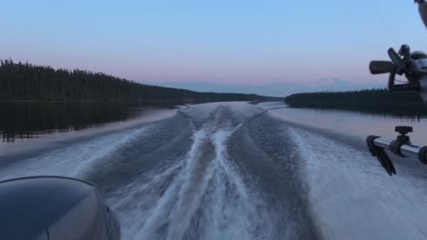 back view of a fishing boat riding at dusk with beautiful colours