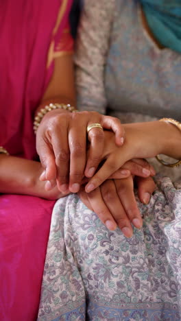 vertical video: holding hands, family showing love and support, wearing traditional indian clothing