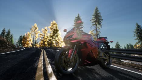 sportbike on tre road in forest with sun beams