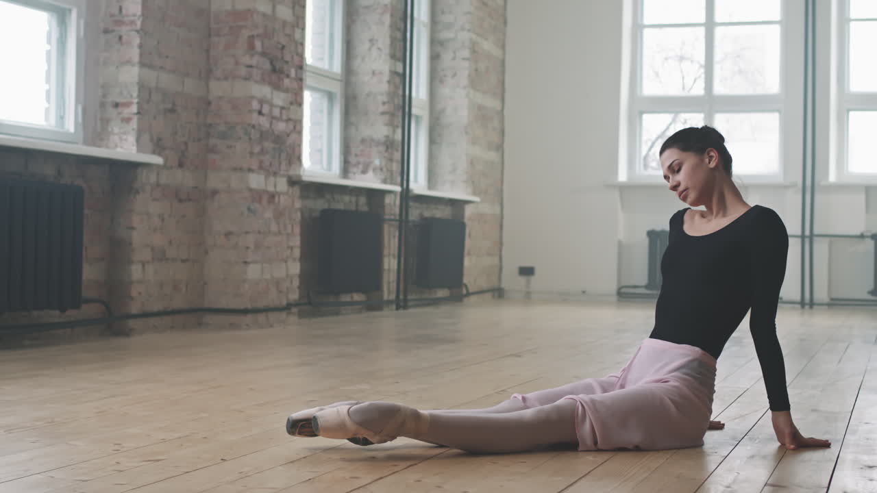 Graceful Ballerina Doing Stretching Exercises On Floor
