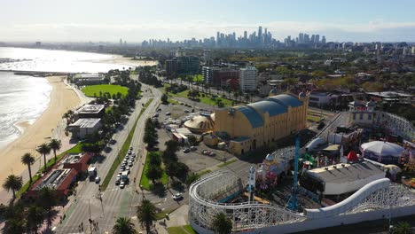 aerial footage flying past st kilda's beach famous amusement park, the luna park melbourne