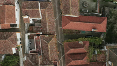 top view of white houses with red tiled roofs in obidos village, portugal - aerial drone shot