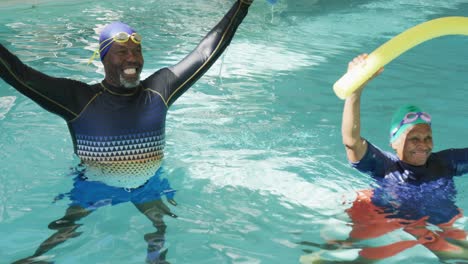 video of happy african american couple swimming in the pool