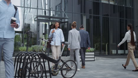 employee walking out office take electric scooter. shared urban mobility device.