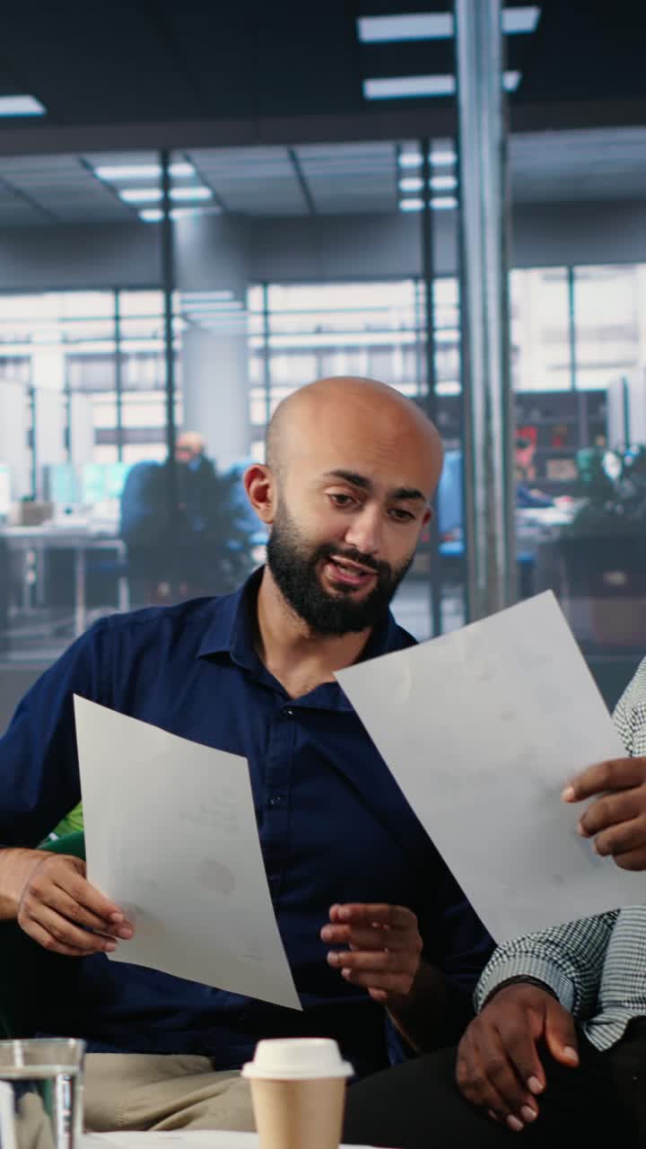 Vertical Video Goal oriented female boss answering a phone call during a meeting