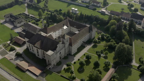 abbey seen from above, surrounded by vegetation and trees