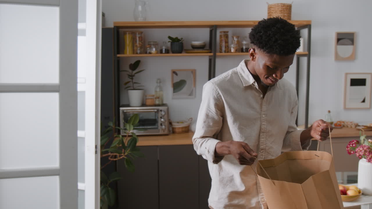 Man Receives Delivery in Kitchen