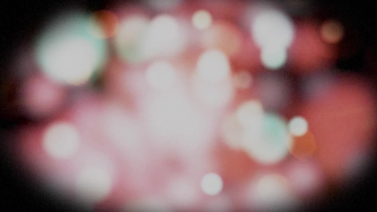 Animation of colourful moving spots on black background