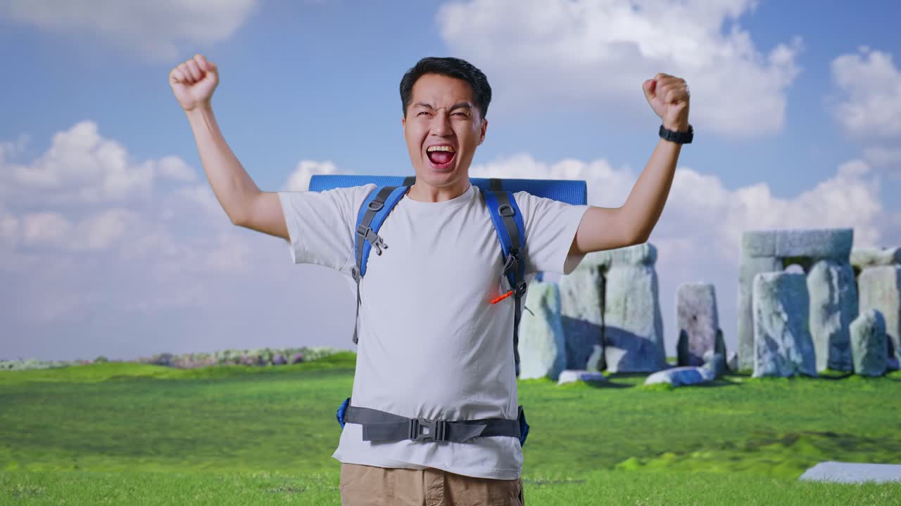 Asian Male Hiker With Mountaineering Backpack Screaming Goal Celebrating The Success While Traveling In Stonehenge