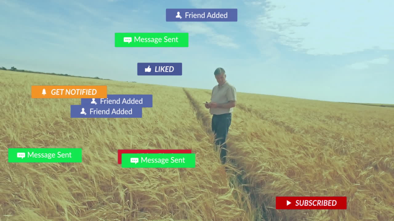 Man holding tablet standing in wheat field, projecting floating social media tech notifications