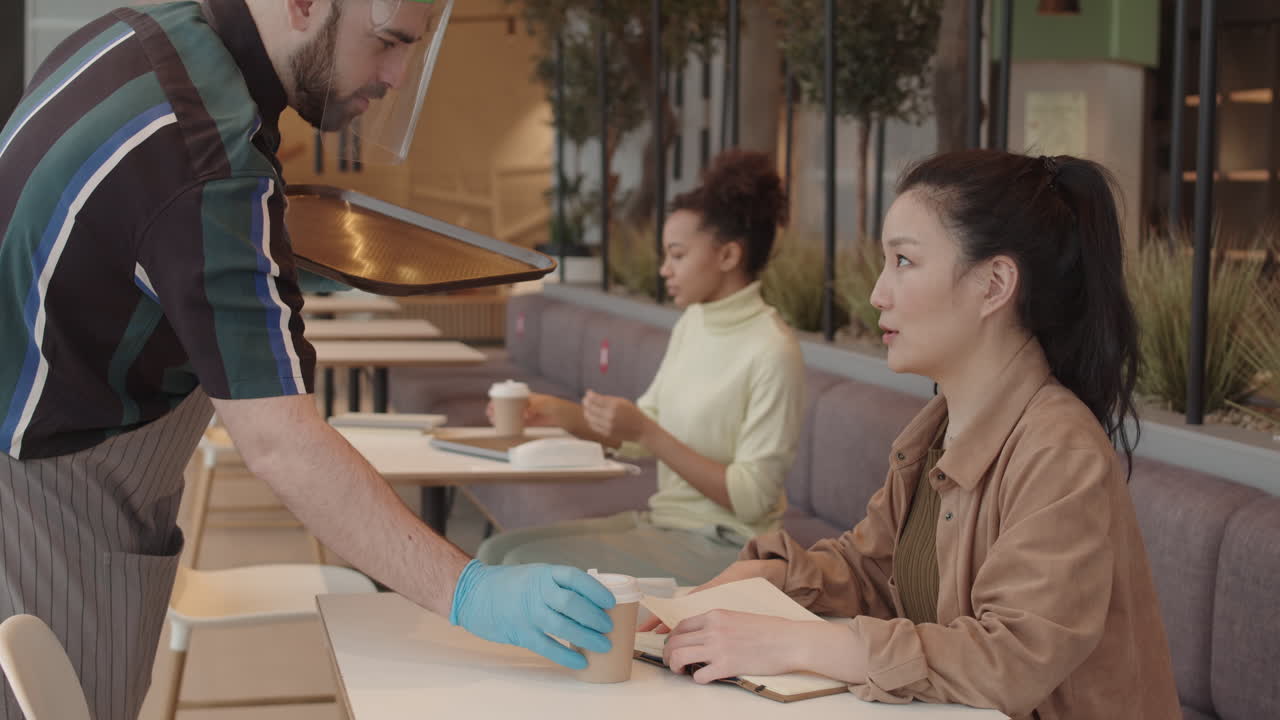 Waiter Serving Coffee in Paper Cups