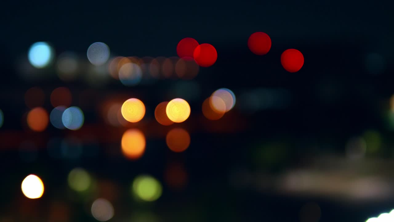 bokeh de fondo de rascacielos en la ciudad con luces y círculos de colores borrosos en la noche