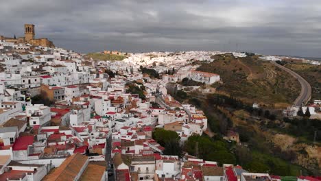 Flying-over-narrow-streets-of-typical-small-village-in-Andalusia,-Spain