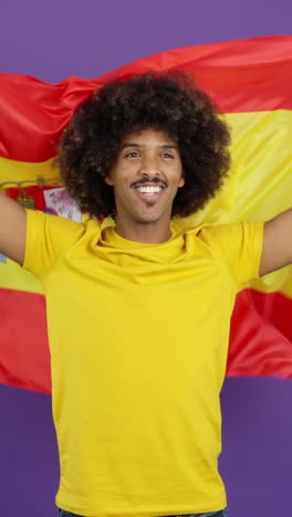 man with afro and moustache cheering with spanish flag