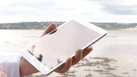 close up of man using his tablet pc