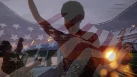 Animation-of-waving-flag-of-usa-over-group-of-friends-having-fun-on-the-beach-and-stadium