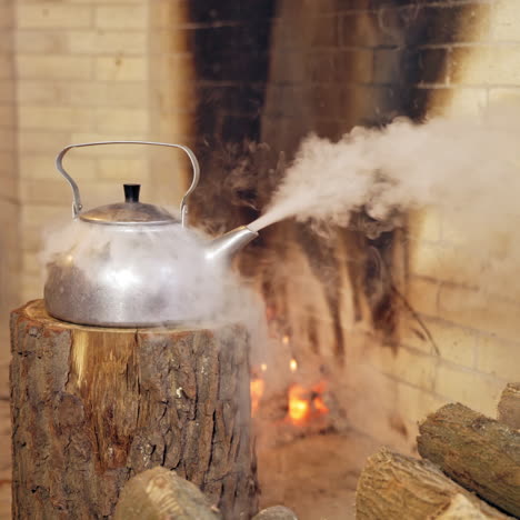 close up of steaming teapot. santa claus's hand is taking the kettle. new year and christmas concept. feast is coming.