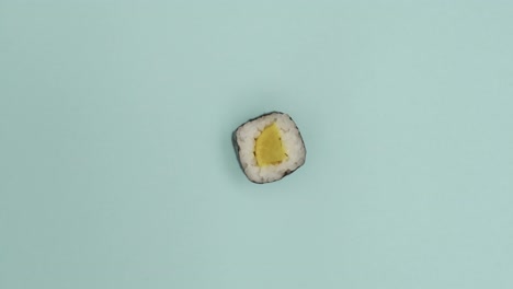 Sushi-roll-rotating-on-blue-background