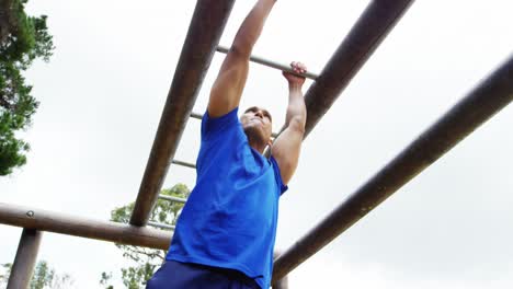 Fit man climbing monkey bars 4k