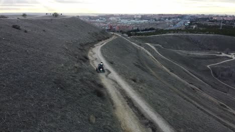 quad driving on a dirt road