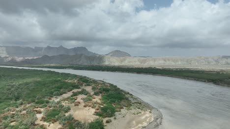 parallax drone shot of long range of mountains and hills with clouds on top of it in hingol, balochistan, pakistan