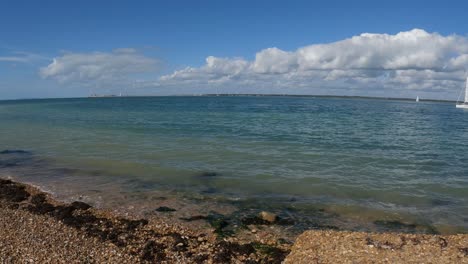 Cristal-clear-water-waves-gently-kissing-the-orange-pebble-beach-in-the-Isle-of-Wight