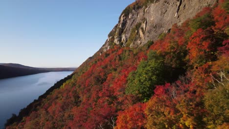 beautiful aerial drone footage of the fall leaves on and around mount hor, mount pisgah, and lake willoughby during peak autumn foliage at willoughby state forest in westmore, vermont