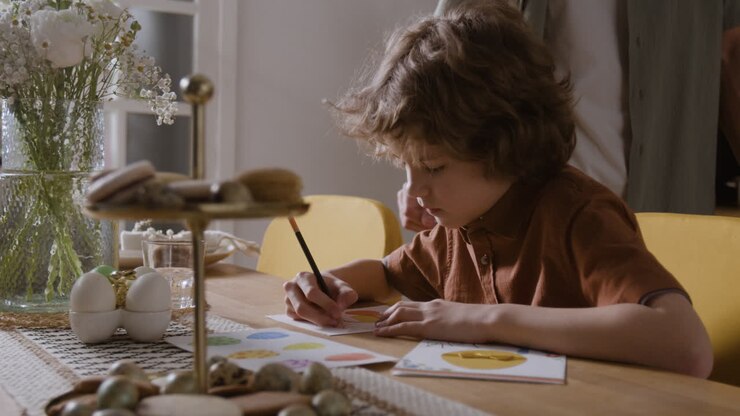 Boy Drawing Easter Cards with Family