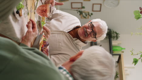 cheerful senior man chatting with friend at holiday dinner