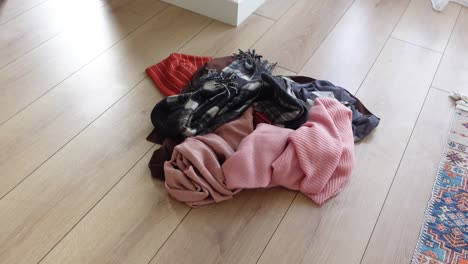 pile of scarves on wooden floor