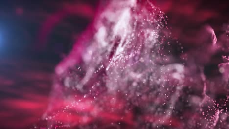 animation of red and pink particle clouds moving on black background