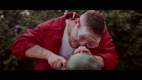 a person carving a pumpkin/watermelon