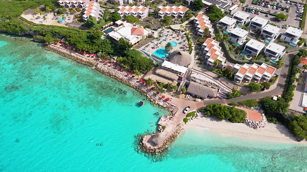 Bird's eye view above Karakter beach and sandy shores with clear Caribbean ocean water