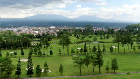 Majestic-Indonesian-landscape-with-city,-nature-and-mountains,-dolly-forward