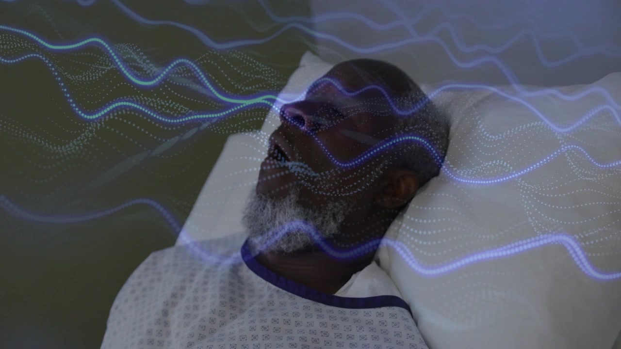 male patient lying on bed blue waves sweeping across face causing eye opening for health monitoring