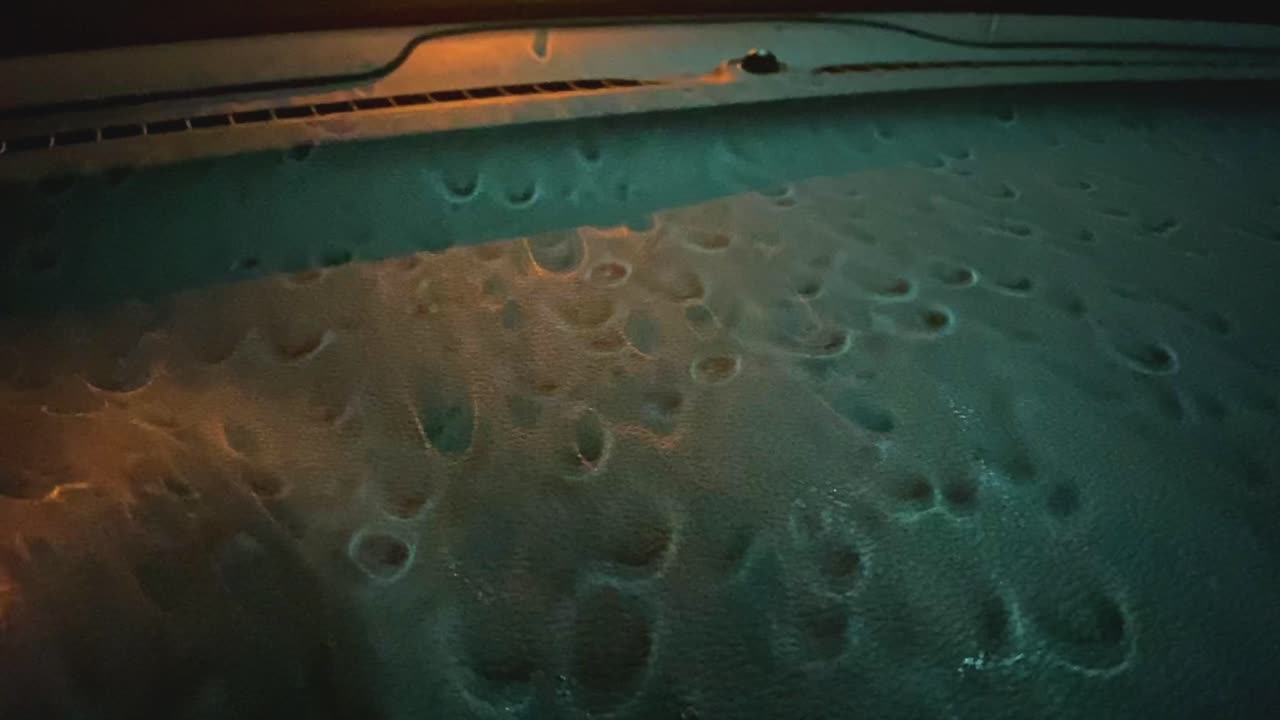 The rain is pouring on the windshield