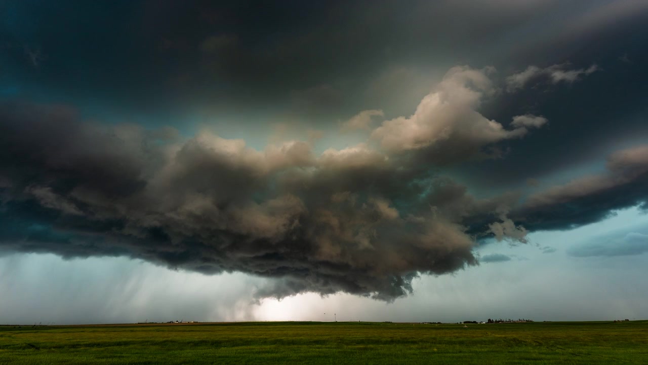 Ominous grey storm clouds sweeping across wide open landscape