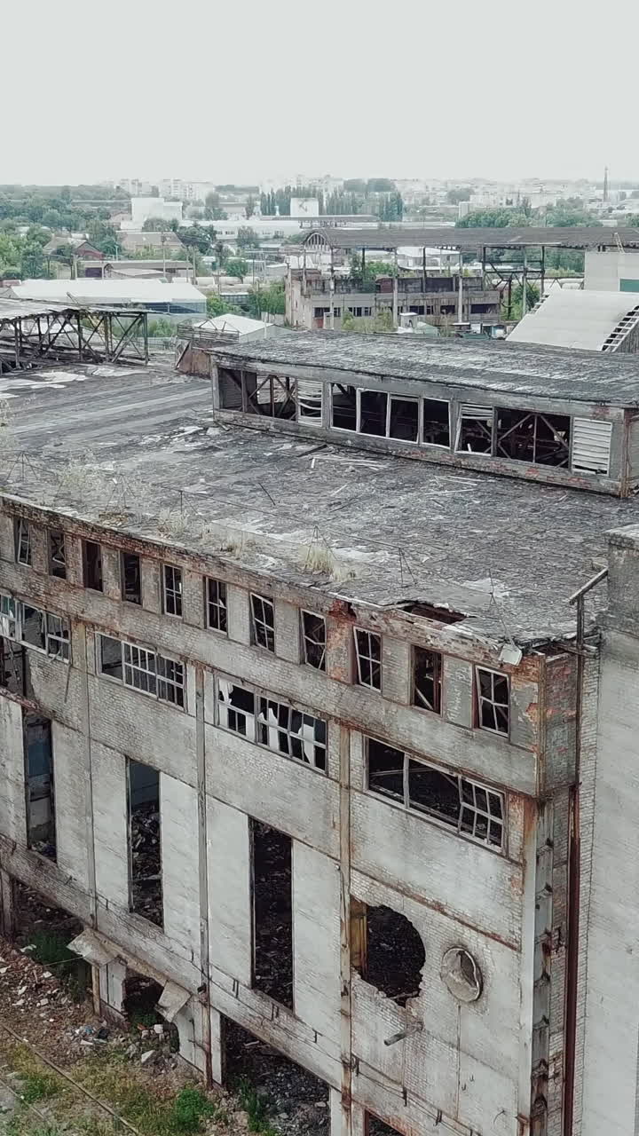 Flight over the destroyed factory. Old industrial building for demolition. Aerial view. Vertical video