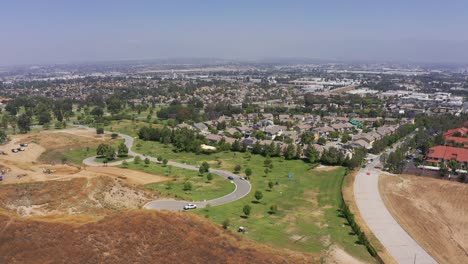 Aerial-wide-descending-shot-of-a-cemetery-lawn-at-a-mortuary-in-California