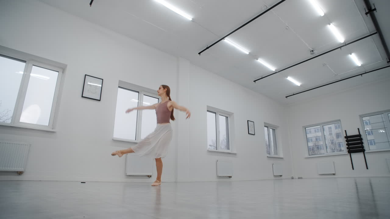 Ballerina Practicing in a White Dance Studio